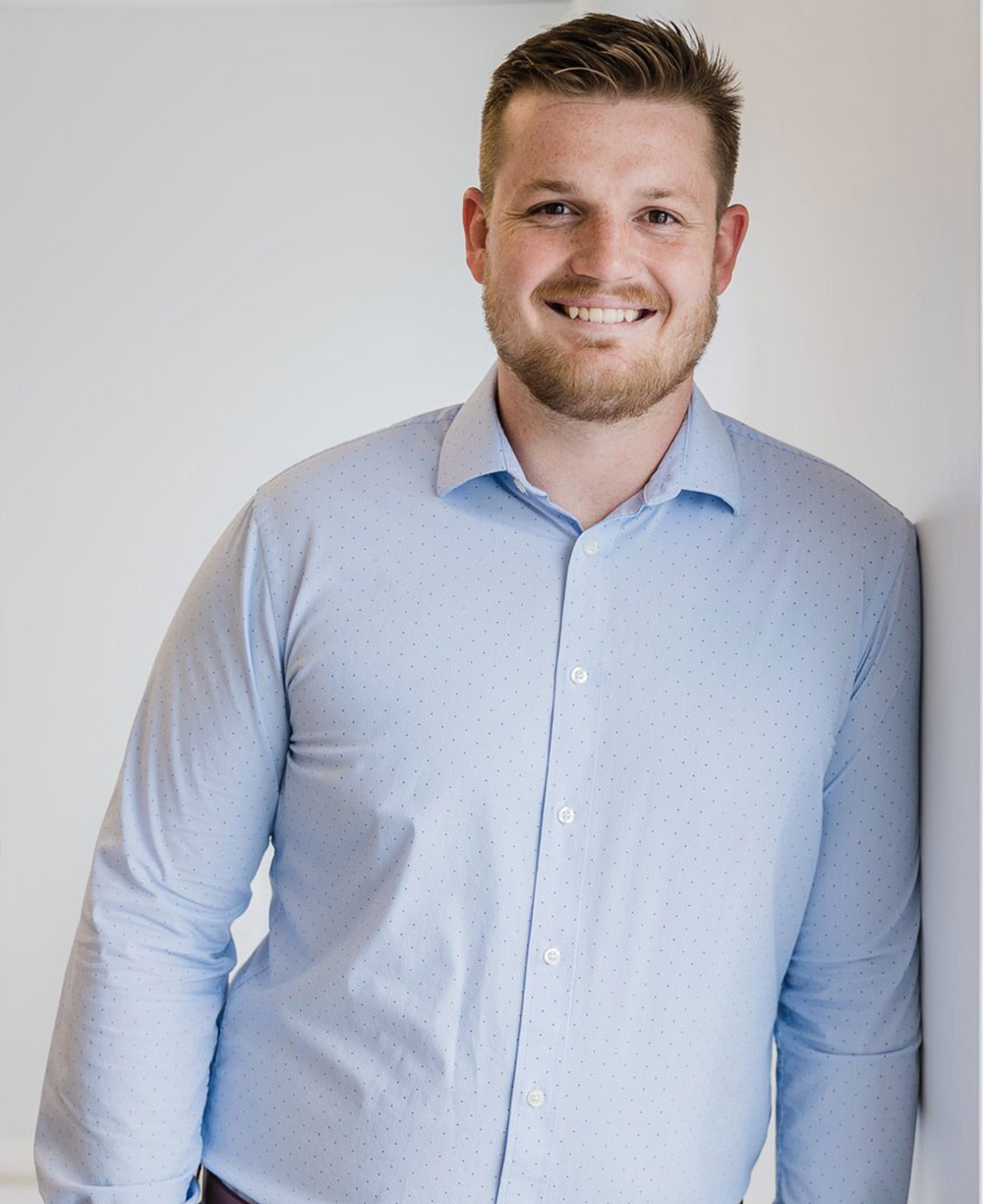 Portrait of Dylan Bostock, Client Liaison at Navigate Cayman, combining local Cayman insight with global experience to support high-net-worth clients